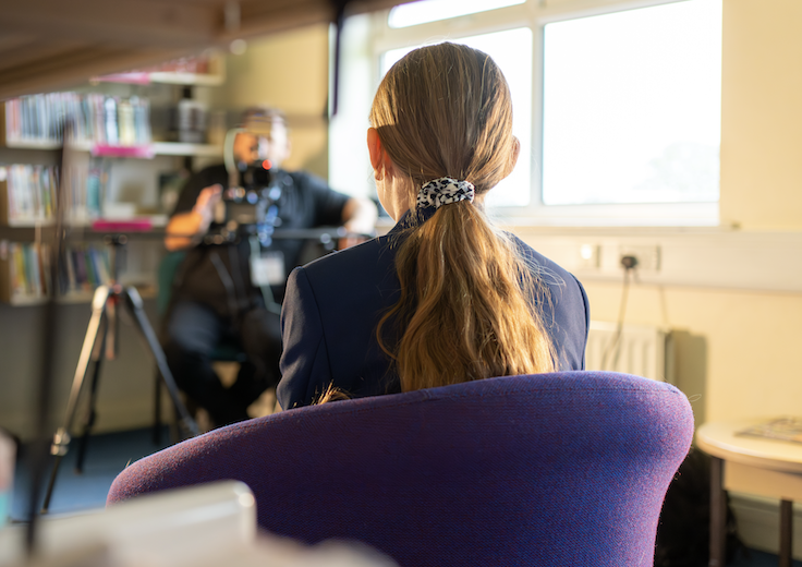 Behind-the-scenes view of a pupil being filmed for a school promotional video